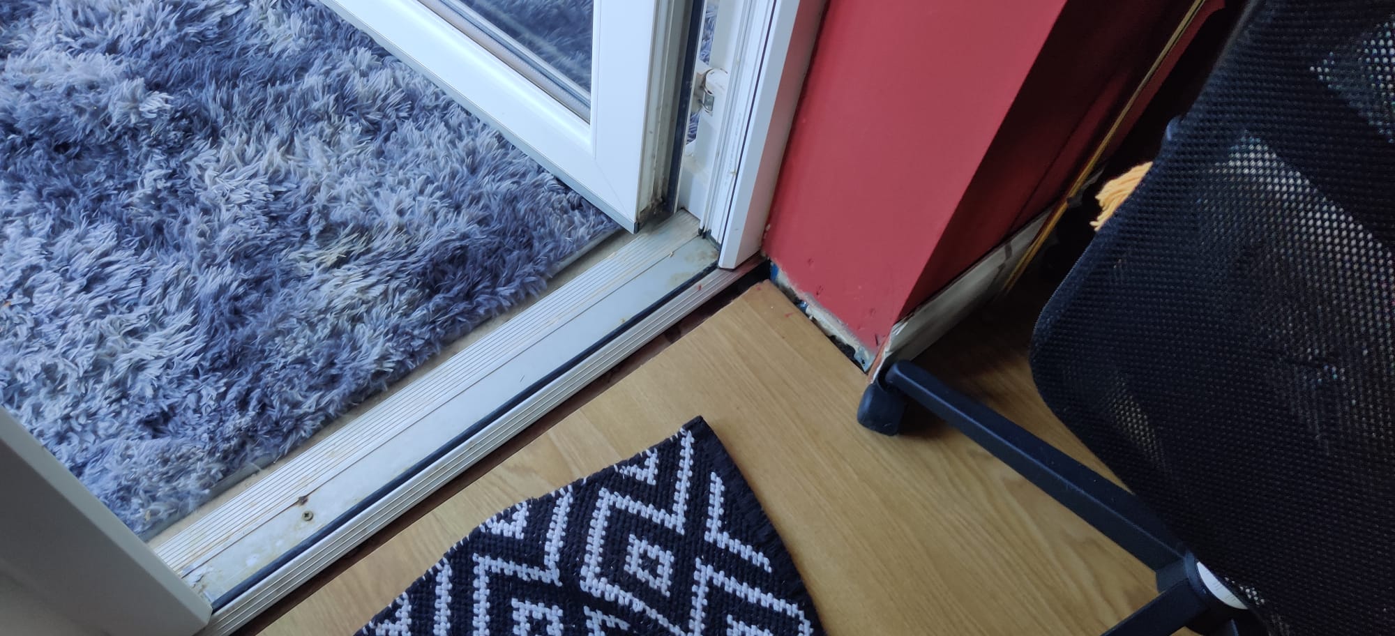 Gap between flooring and door.